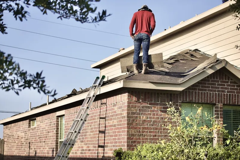 Professional roofer working on a residential roof in Southard